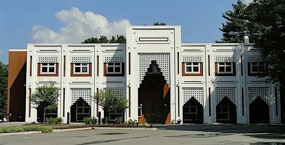 The Islamic Center of Boston building in Wayland: a white facade with lattice-screened archways around a tall central entrance